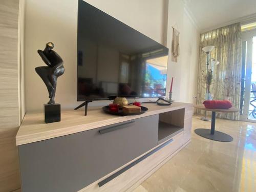a living room with a flat screen tv on a entertainment center at Apartamento Calalbir in Albir