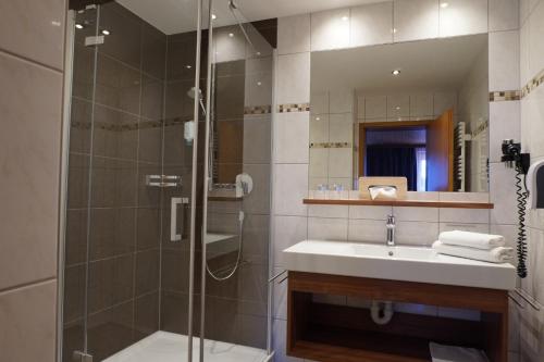 a bathroom with a sink and a shower at Pension Edelweiss in Damuls