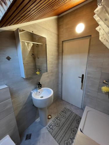 a bathroom with a sink and a toilet and a shower at Apartman Vesna in Igalo