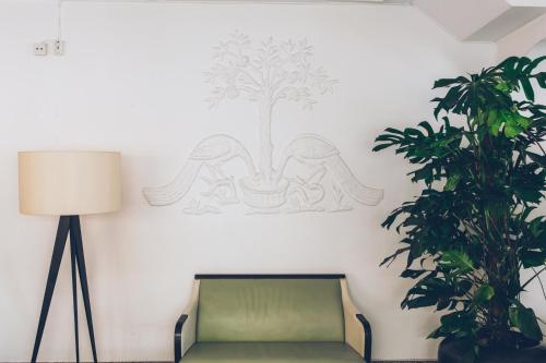 a room with a couch and a tree on the wall at Crystal Plaza Hotel in Stockholm