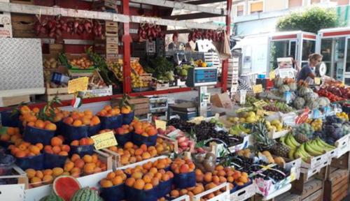 a market with a bunch of fruits and vegetables at Casa An'anasha in Luino