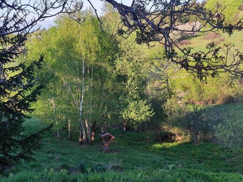 a bird house in a field with trees at Apartmán Bobo in Stožok