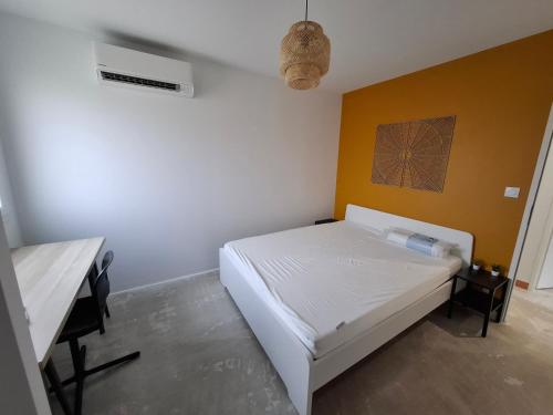 a bedroom with a bed and a desk in it at Maison des libellules de dugradus in Aubenas