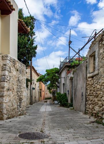 an alleyway in an old town with stone buildings at Kalomiris Thea Suite in Archanes