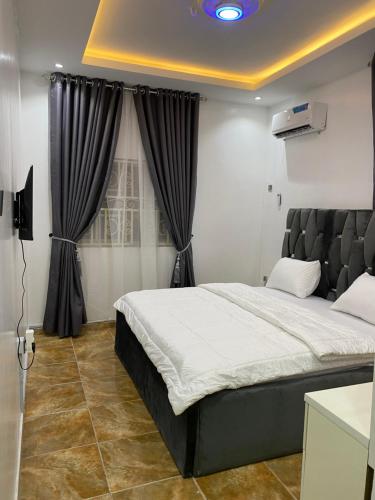 - une chambre avec un grand lit et une fenêtre dans l'établissement Sophy Shortlet, à Abuja