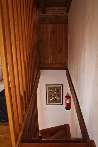 a wooden staircase with a picture and a fire extinguisher at La casuca de Cecilia in Pedreo