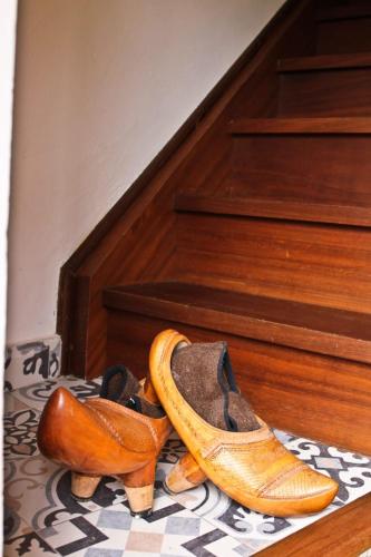 two pairs of shoes sitting on the floor next to stairs at La casuca de Cecilia in Pedreo