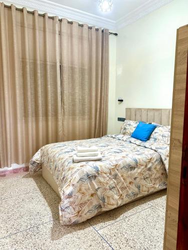 a bedroom with a bed with two towels on it at Jolie Appt à skhirat 5min de la plage par voiture in Skhirat