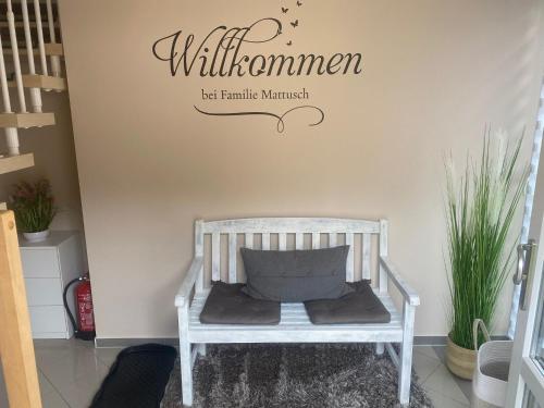 a white crib in a room with a sign on a wall at Ferienwohnung Am Waldesrand - Garten, Terrasse, Grill, Massagesessel, Kinderspielecke, Spielekonsole in Cottbus