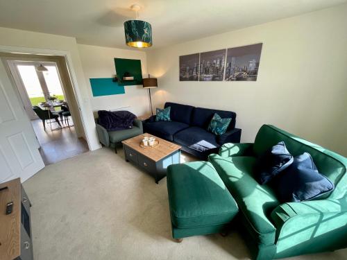 a living room with a couch and a table at 3-Bedroom Luxury Stay With FREE Parking in Market Harborough