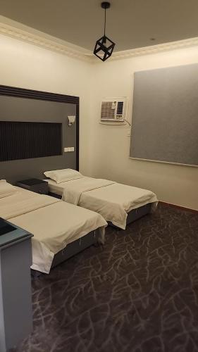 Ένα ή περισσότερα κρεβάτια σε δωμάτιο στο جوهرة المطار