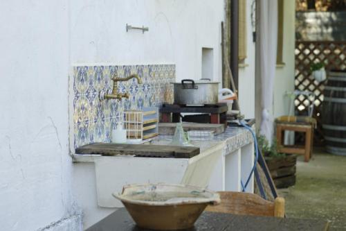 a kitchen with a counter with a sink and a stove at B&B Chalet tra le vigne in Atri