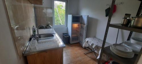 a kitchen with a sink and a refrigerator at Boka Bay in Tivat