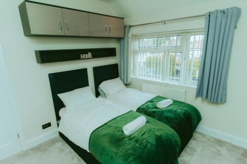 a bedroom with a bed with two white objects on it at Detached 4 Bed - Pool Table-Patio-BBQ-Table Tennis in Quinton
