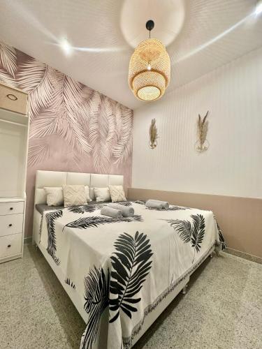 a bedroom with a large bed with a plant mural at Ferienwohnung Lauri Sommeraktion 2025 in Bayreuth