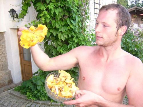 a man holding a bowl of food and a flower at Pleasant apartment in Bavaria in Neureichenau