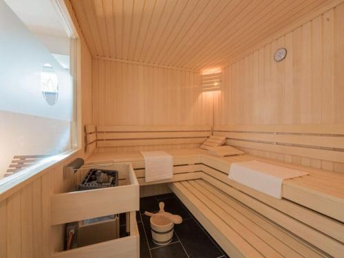 a sauna with two beds and a stove in it at Holiday apartment Waldfrieden in Kurort Bärenburg