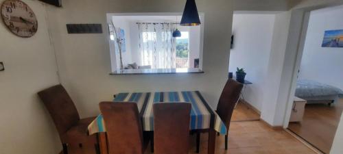 a dining room with a table and chairs and a mirror at Boka Bay in Tivat