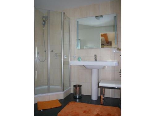 a bathroom with a sink and a shower at Luxury holiday home with sauna in Heiligendamm