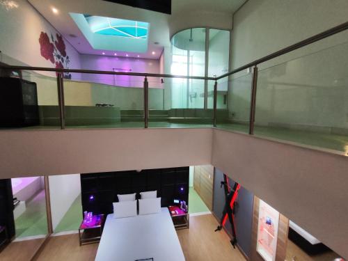 a view of a room with a table and a balcony at Motel Confidence in Santo André