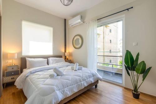 Ένα ή περισσότερα κρεβάτια σε δωμάτιο στο Alimos Grandeur: The Residence