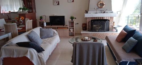 sala de estar con sofá y chimenea en Sea Side View, en Agia Paraskevi
