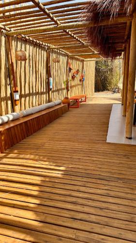 a wooden walkway with a bench on top of a building at Pousada Alto Mar in Fernando de Noronha