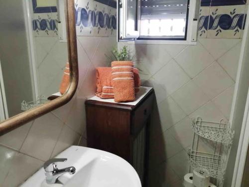 a bathroom with a sink and a mirror and towels at Casa vacacional con piscina privada in Dolores