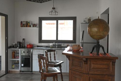 a kitchen with a table and chairs and a bowl on a desk at Moller Masi - Ayllu Huasi in Purmamarca