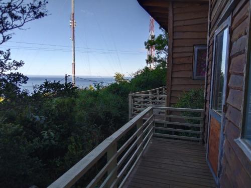 a porch of a house with a view of the ocean at CABAÑAS ALTO BELLAVISTA NIEBLA in Niebla