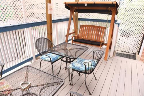 a patio with chairs and a table and a bench at Duo Housing in Washington