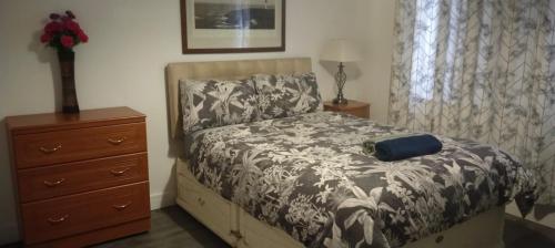 a bedroom with a bed and a dresser at White House Ensuite double bedroom in Warrington