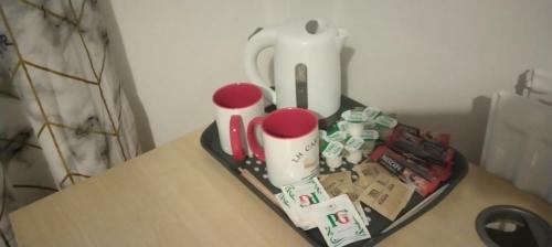 a tray with various items on a table at White House Ensuite double bedroom in Warrington