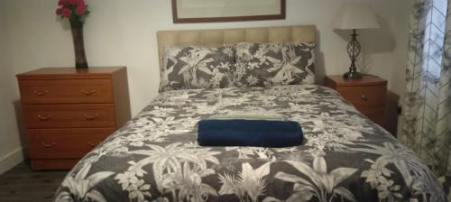 a bedroom with a bed with a black and white comforter at White House Ensuite double bedroom in Warrington