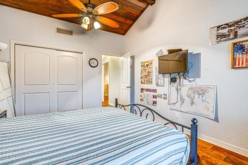 a bedroom with a bed and a ceiling fan at Lago Vista Golf Getaway with Decks and Pool Access! in Lago Vista
