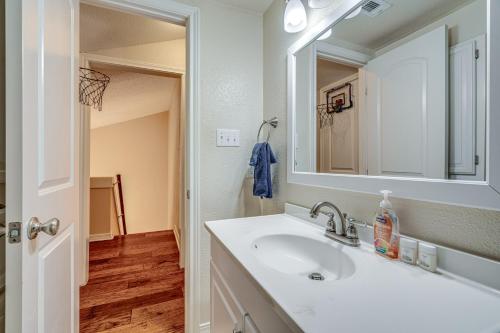 a bathroom with a sink and a mirror at Lago Vista Golf Getaway with Decks and Pool Access! in Lago Vista