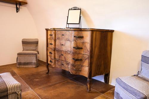 a wooden dresser with a mirror on top of it at Ca'Toni in Bagnone