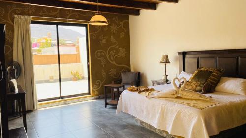 a bedroom with a bed and a large window at Mansión Leonor in Bernal