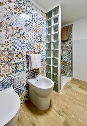 a bathroom with a toilet and a sink at La Stalla in Porto Santo Stefano