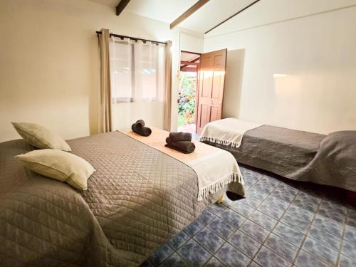 a bedroom with two beds and a window at Hostal Vaianny in Hanga Roa