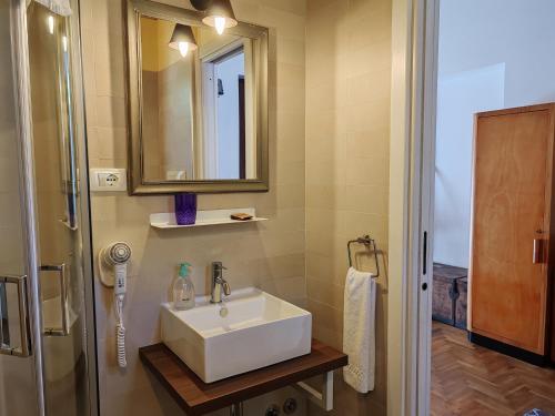 a bathroom with a white sink and a shower at Taverna Centomani in Potenza