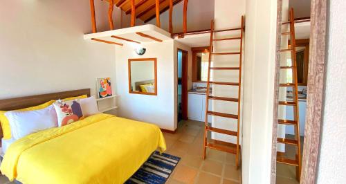 a bedroom with a yellow bed and a ladder at Palma Sol in Pampatar