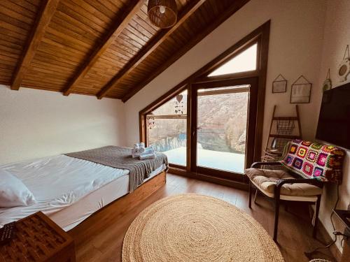 1 dormitorio con cama y ventana grande en Haremi Garden Suit Bungalovs, 