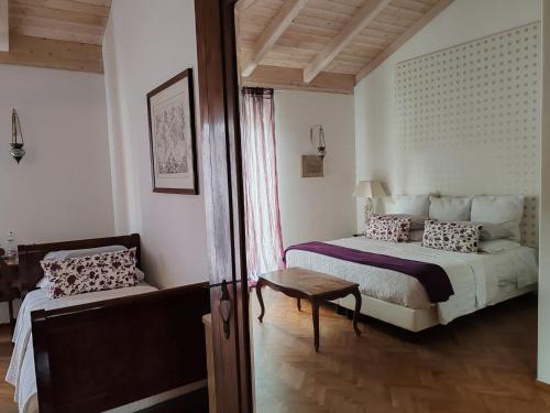 a bedroom with a bed and a table and a window at Taverna Centomani in Potenza