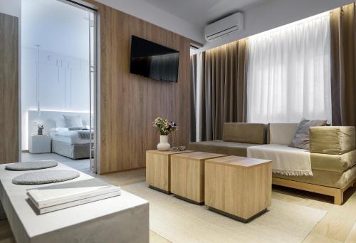 a living room with a couch and a tv at Heritage & Tales: Sihna in Litochoro