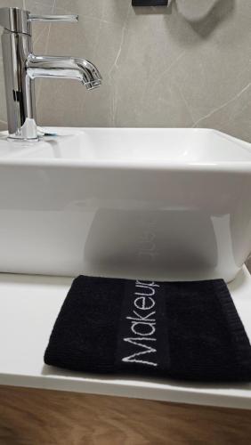 a black rug is sitting under a sink at Sezame in Ioannina