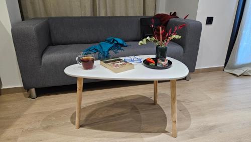 a coffee table with a book and a vase of flowers at Sezame in Ioannina