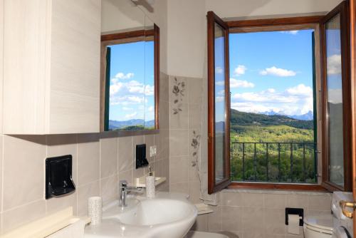 a bathroom with a sink and a window with a view at Ca' Toni d'sovra in Bagnone