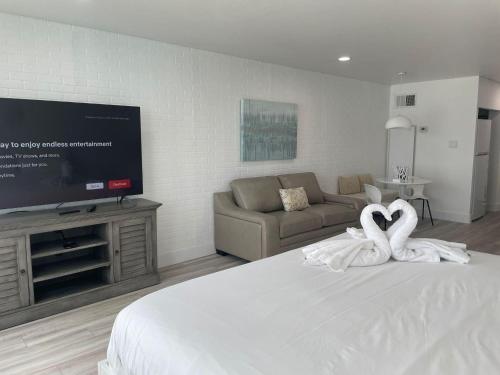 a bedroom with a bed with two white swans at Top of the Gulf 815 in Panama City Beach