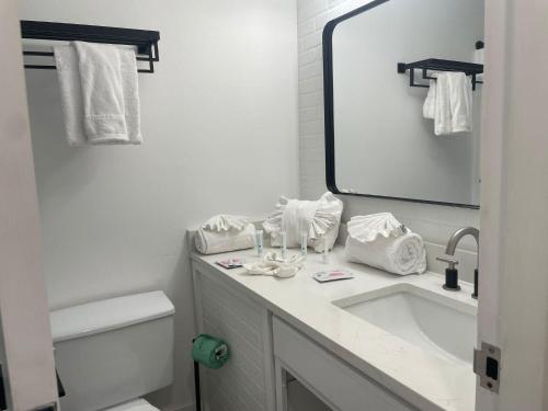 a white bathroom with a sink and a mirror at Top of the Gulf 815 in Panama City Beach